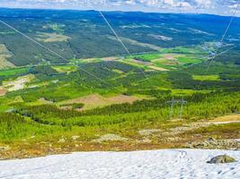 Power pole and panorama Norway Hemsedal with snowed in Mountains. photo