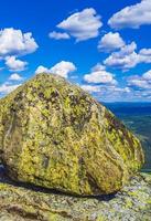 Huge rock big boulder snowed in Mountains panorama Norway Hemsedal. photo