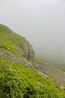 Fog, clouds, rocks and cliffs on Veslehodn Veslehorn mountain, Norway. photo
