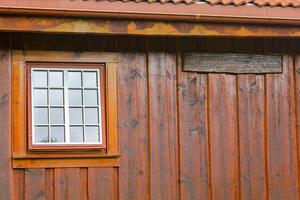 Wooden wall, window and door texture of Norwegian cabin hut.. photo