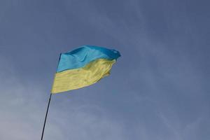 Ukrainian yellow and blue flag develops in the wind against the sky photo