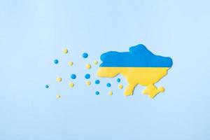 Silhouette of Ukraine yellow-blue colors and dots in Europe - a symbol of migrants to the west photo