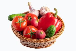 Assorted fresh vegetables in a basket on a white background. photo