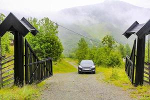 Beautiful black wooden cabin hut with a parked car, Norway. photo