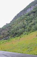 Wet road to a tunnel in the mountains, Hemsedal Norway. photo