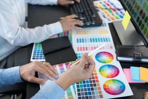 diseñador gráfico o creativo trabajando juntos coloreando usando una tableta gráfica y un lápiz en el escritorio con un colega.