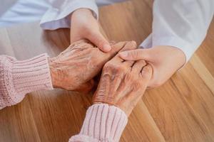 The doctor shook the patient's hand as a sign of encouragement. photo