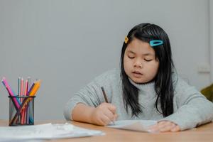 Asian girls sit and work for teachers. photo