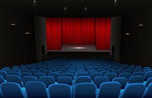 Theater stage with red curtains and blue seats