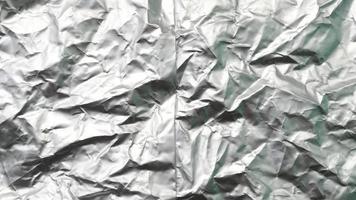 Silver foil with rough texture for background,crumpled paper, uneven surface. photo