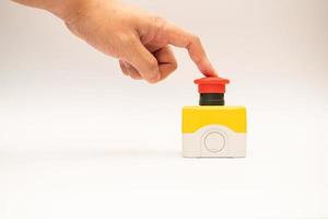Stop Red Button and the Hand of Worker About to Press it. emergency stop button. Big Red emergency button or stop button for manual pressing. photo