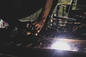 welder, welding automotive part in a car factory photo