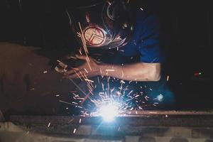 welder, welding automotive part in a car factory photo