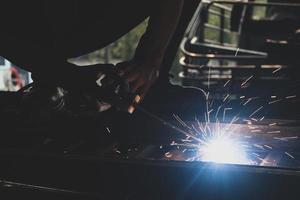 welder, welding automotive part in a car factory photo