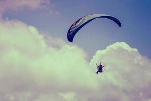 paramotor flying on sky with cloud background photo