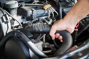 Technician to inspect radiator hose,Maintenance concept photo