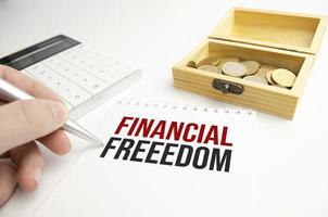 Text financial freedom on note paper on office table photo