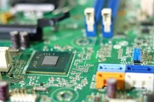 Electronic circuit boards on green background, selective focus photo