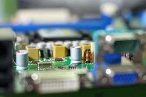 Electronic circuit boards on green background with chip slot , selective focus photo