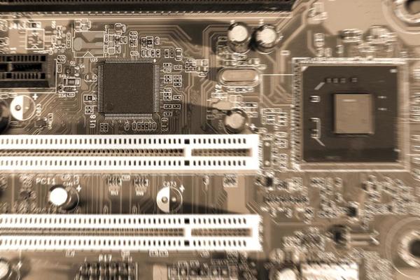 Electronic circuit boards on brown background with chip slot , selective focus