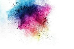 Multicolored powder explosion on white background.Launched colorful particles on background. photo