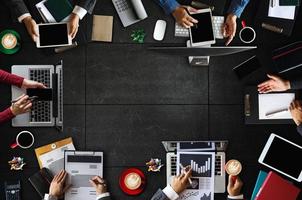 Top view of business Group of Multiethnic Busy People meeting with other in modern office with laptop computer, smartphone, tablet, coffee and document photo