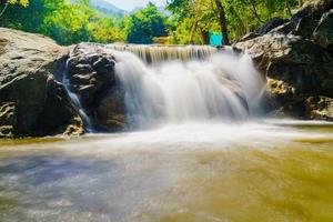 Water flowing along rocks in nature, waterfall photo