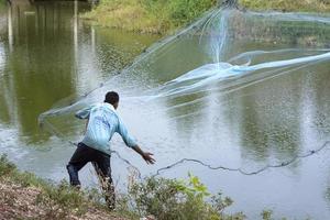 Chaiyaphum, Thailand - APR 12, 2015 - fisherman or fisher is someone who captures fish and other animals from a body of water, or gathers shellfish. For some communities. photo