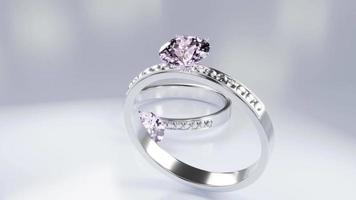 Diamantringe aus Platingold verziert mit vielen kleinen Diamanten auf einer Marmoroberfläche. Eleganter Diamant-Hochzeitsring für Frauen. 3D-Rendering video
