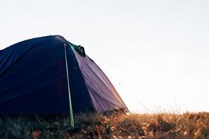 Pitched tent in campsite in the mountains. photo