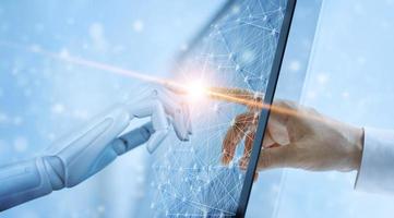 Hands of robot and human touching on global virtual network connection future interface. Artificial intelligence technology concept. photo