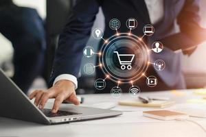 Digital marketing. Businessman working with laptop computer, tablet and smart phone. Modern interface payments online shopping and icon customer network connection on virtual screen. photo
