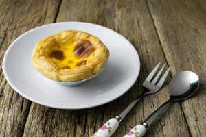 delicious portuguese egg tart on wood background photo