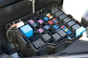 Detail of a car engine bay with fuses photo