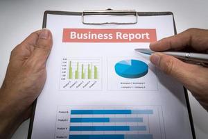 business report and man hand. photo