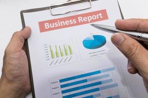 business report and man hand. photo