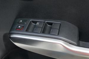 car interior details of door handle with windows controls and adjustments photo