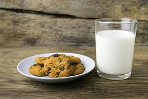 cookies and a glass with milk with a white note for santa photo