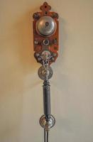 Vintage telephone hanging from a wall photo