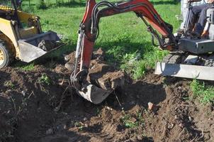 Excavator digging a hole photo