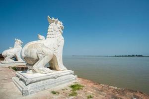 The twin Lion statue standing behind the Ayeyarwady River in Myanmar. photo