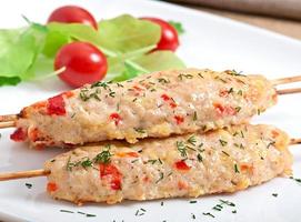 shish kebab of chicken with peppers and cheese photo