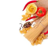 Pasta spaghetti, vegetables, spices isolated on white photo