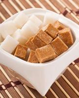 Close-up of cubes of brown and white sugar photo