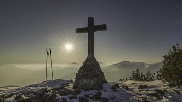 Cross of summit of a mountain photo