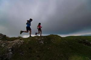 Sportive couple practice mountain trail running photo