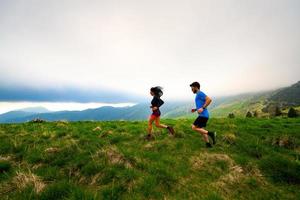 Training for a couple of long distance trail running athletes in the mountains photo