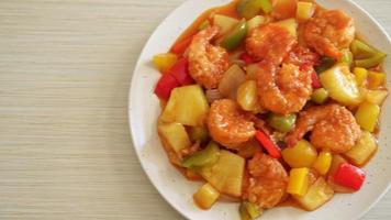 Stir-fried sweet and sour with fried shrimp on plate - Asian food style