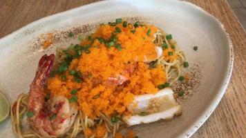 stir-fried angle hair spaghetti with seafood and shrimp egg on plate