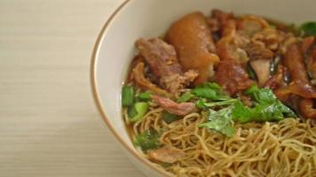 Stewed pork leg noodles in brown soup